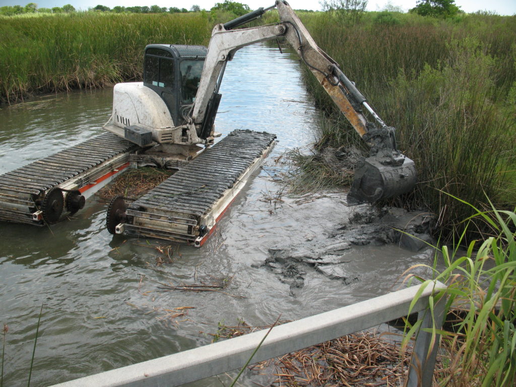 excavator cleaning canal